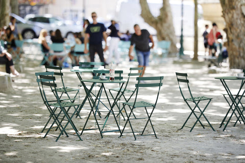 Fermob Bistro chairs and tables in a park.