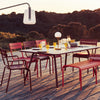 Luxembourg dining set with long table at dusk set for a party.
