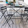 Anthracite bistro chairs and rectangular table on wood deck.