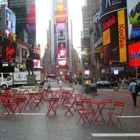 Red bistro chairs and tables in Time Square.