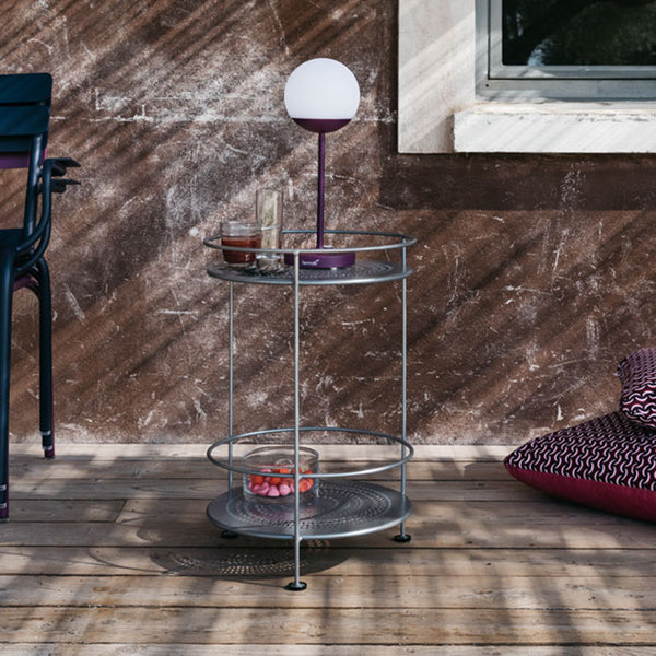Fermob Guinguette Side Table on a deck with a purple MOOOn Lamp